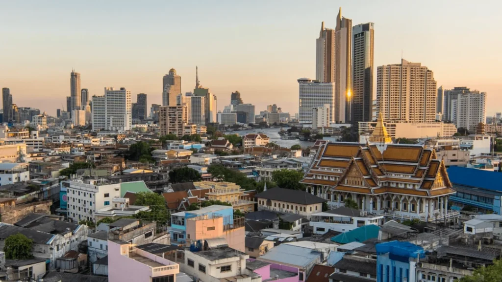 Panoramic view of a modern Thai city with skyscrapers, bustling streets, and a mix of contemporary and traditional architecture.